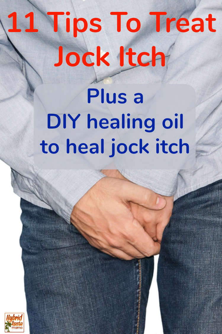 A man in blue jeans holding his groin from the irritation of jock itch