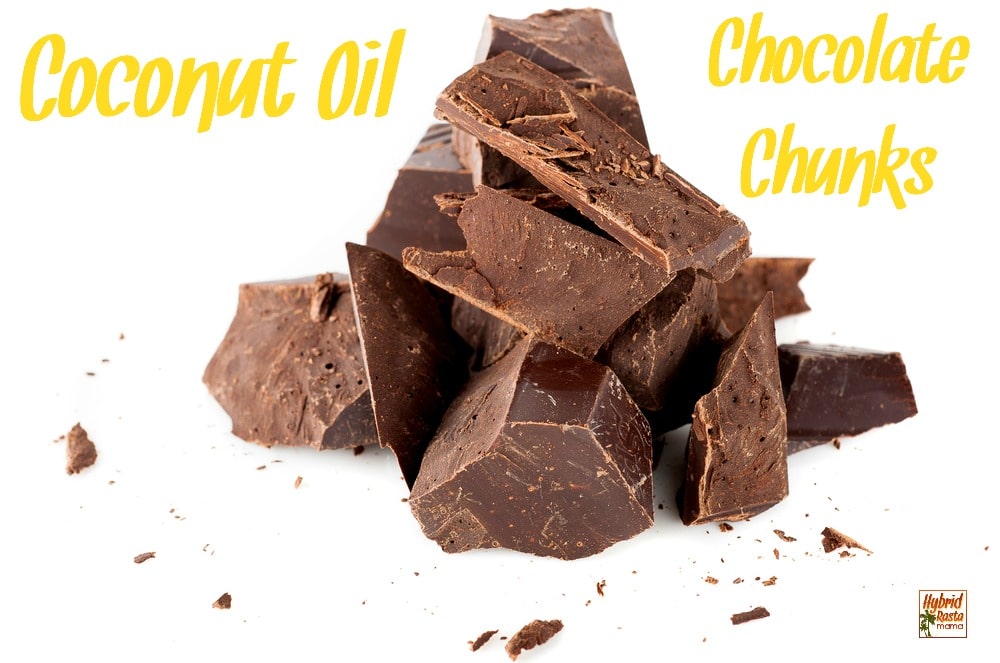 Coconut oil chocolate chunks in a pile on a white background