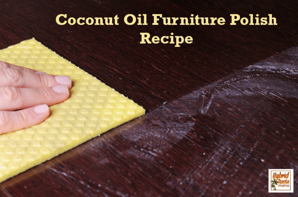 Someone using a yellow cloth with coconut oil furniture polish on a dark desktop