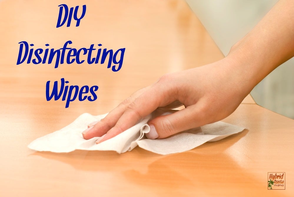hand with DIY disinfecting wipes cleaning table