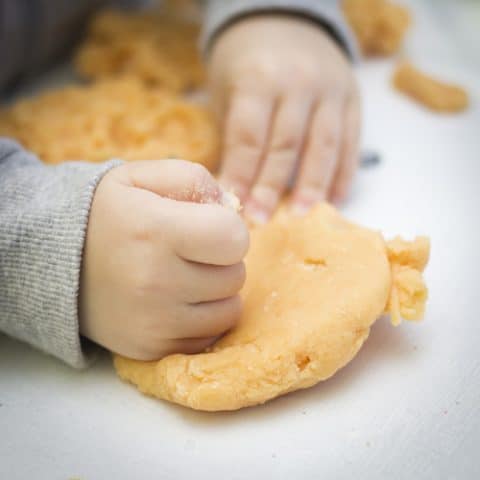 Young boy playing with apple cinnamon dough