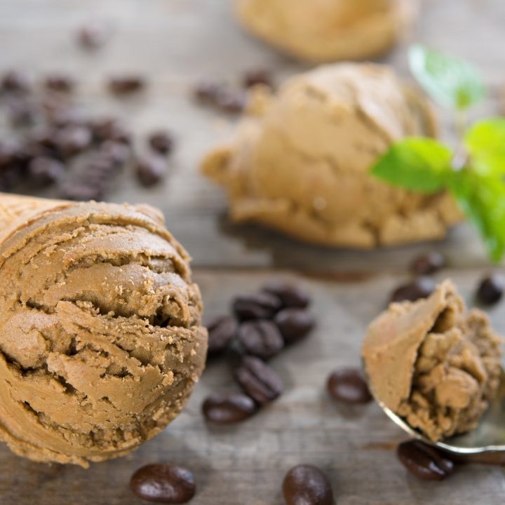 Close up low carb coffee ice cream and coffee beans on old rustic vintage wooden background.