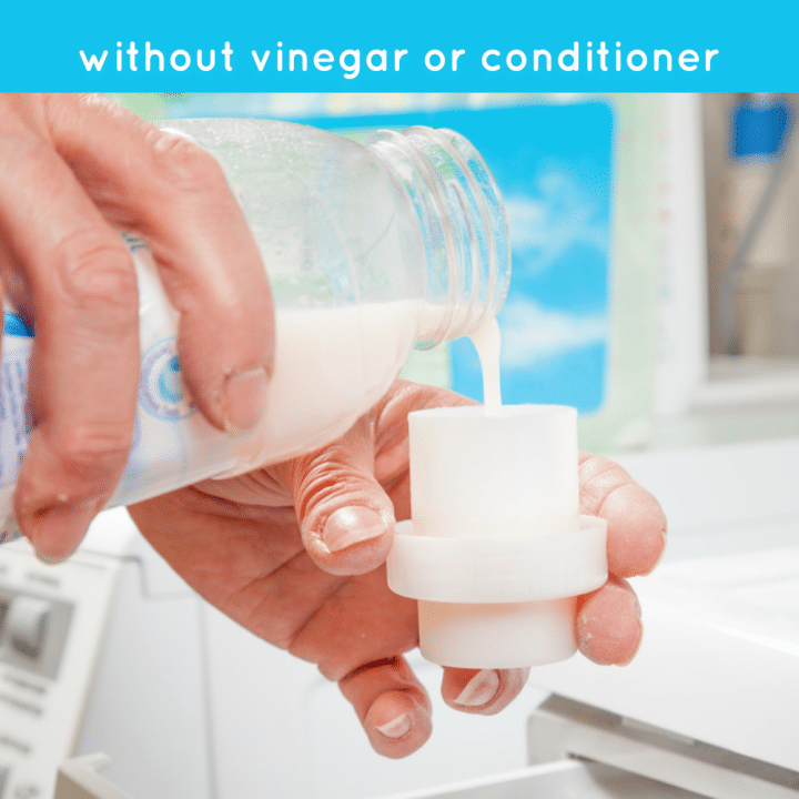 A hand pouring easy DIY fabric softener