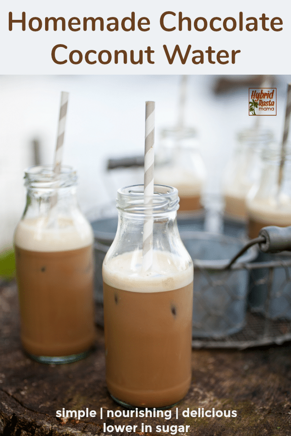 Two small milk bottles of homemade chocolate coconut water with straws in them